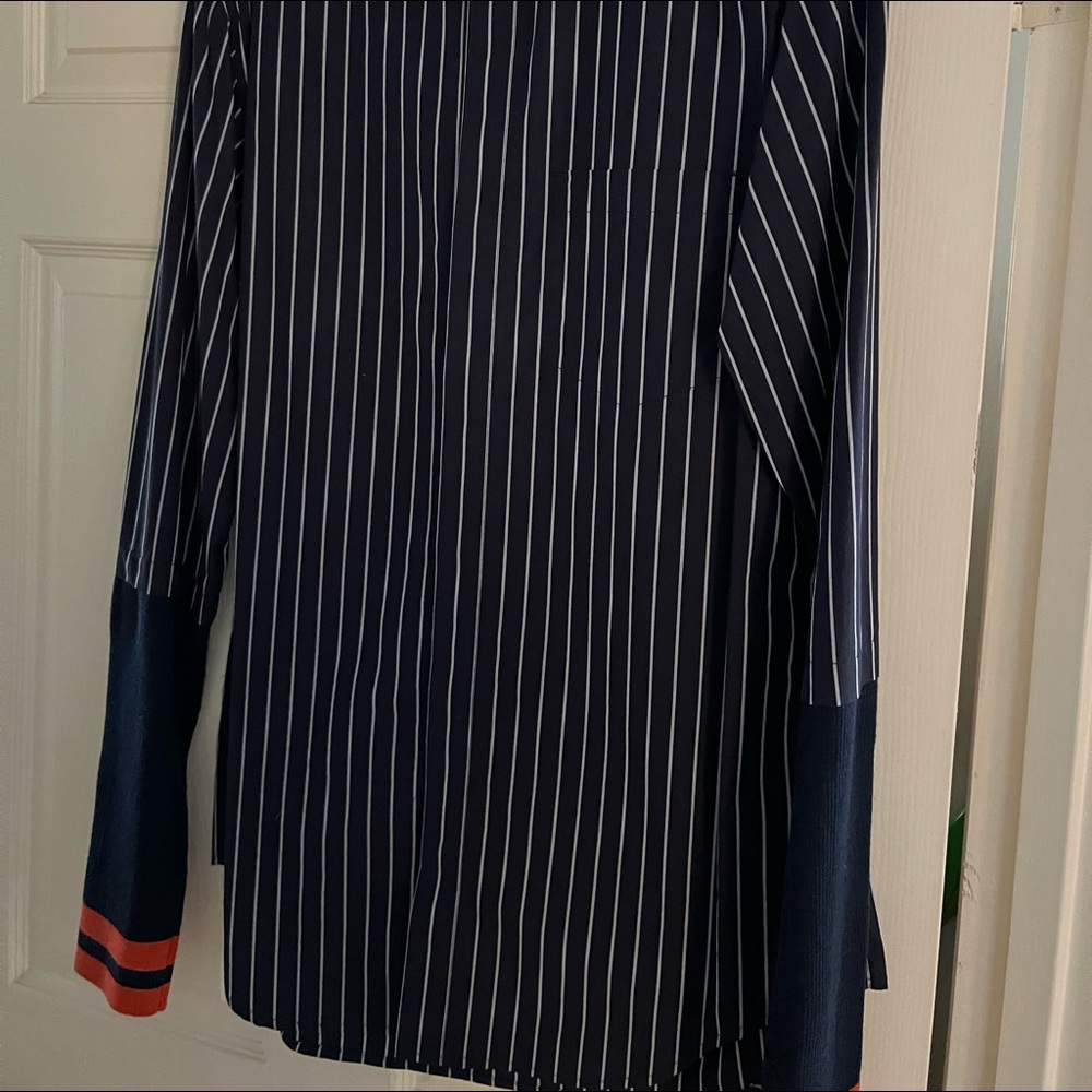 Never worn. Just tired on. Button up with cotton arms